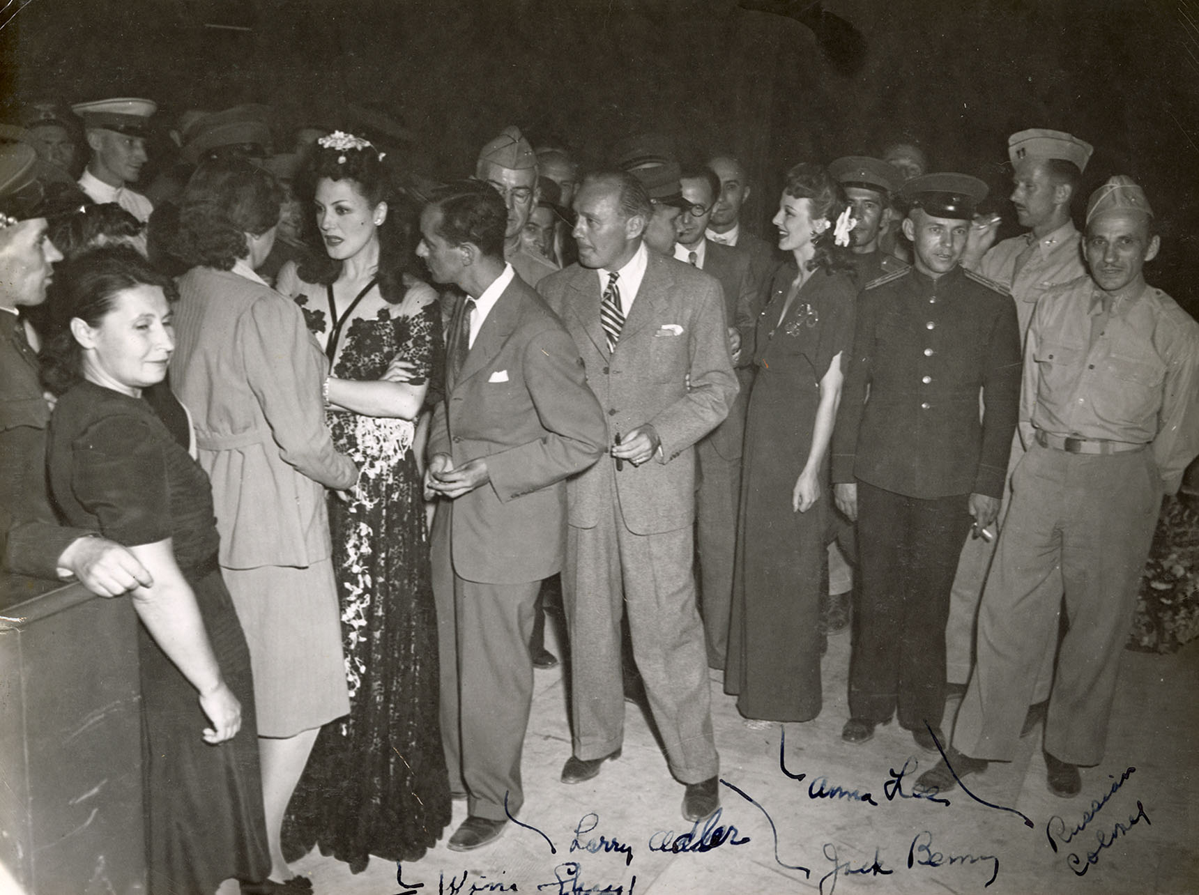 Several well-dressed people milling around indoors Several well-dressed people milling around indoors